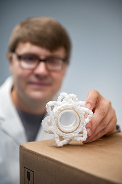 Oleksiy Kovtun investigates the structure of molecular delivery trucks in our cells. In the photo, he shows the 3-D model of one of these trucks, called Retromer.