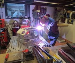 Figure 1: The institute's infrastructure and master craftsman allow us to construct unique instruments for investigations of molecular intereactions at surfaces. Here a dual molecular beam source is being welded together, for use in velocity resolved kinetics experiments